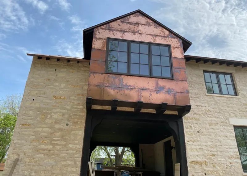Copper metal panel facade on a stone building for Metal Roof Coating in Gardner